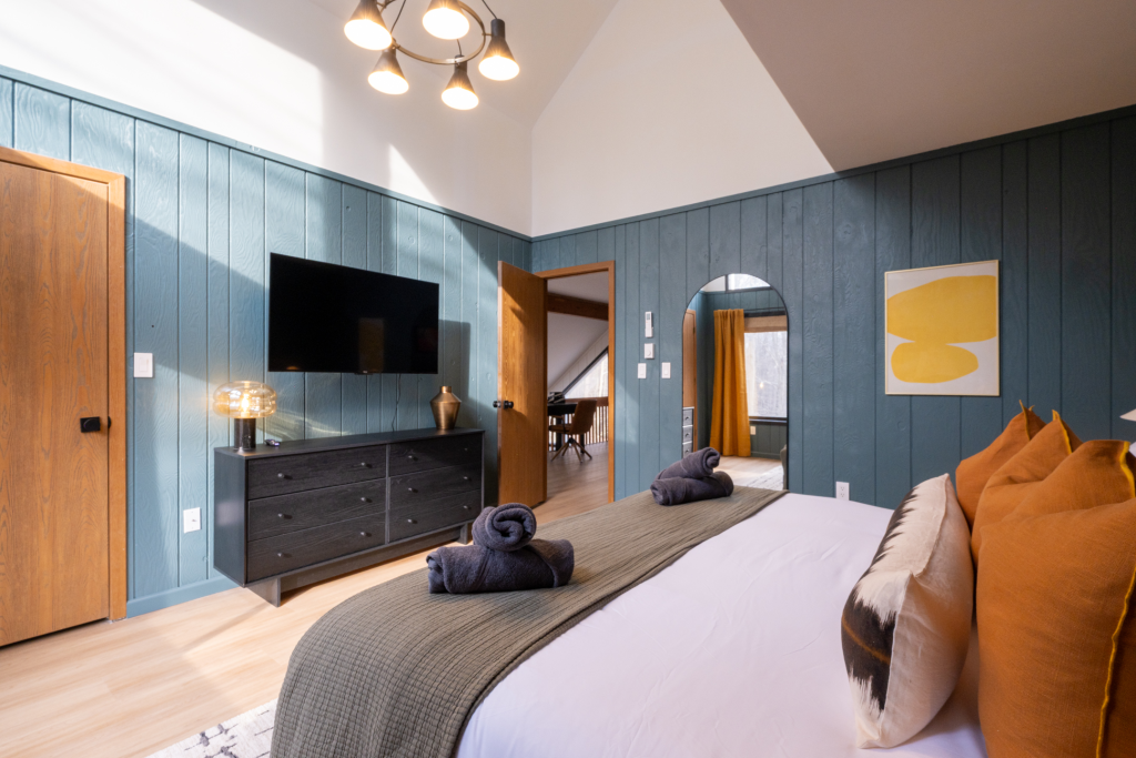 Primary bedroom with vaulted ceiling.